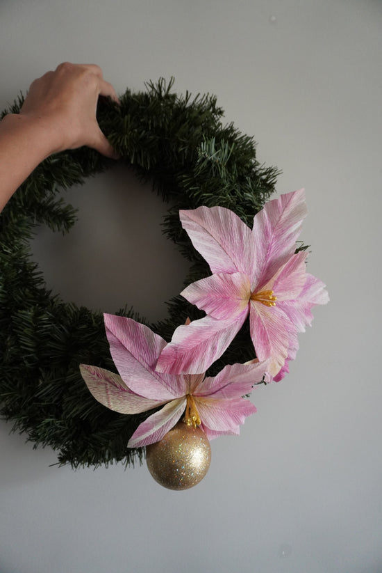 Holiday wreath with pink poinsettias